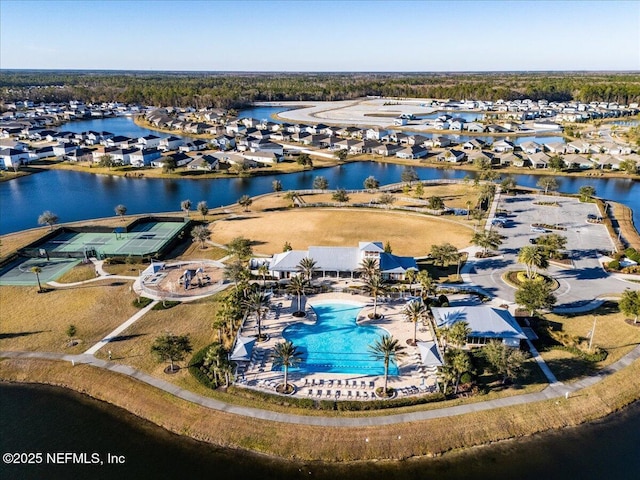 drone / aerial view featuring a residential view and a water view