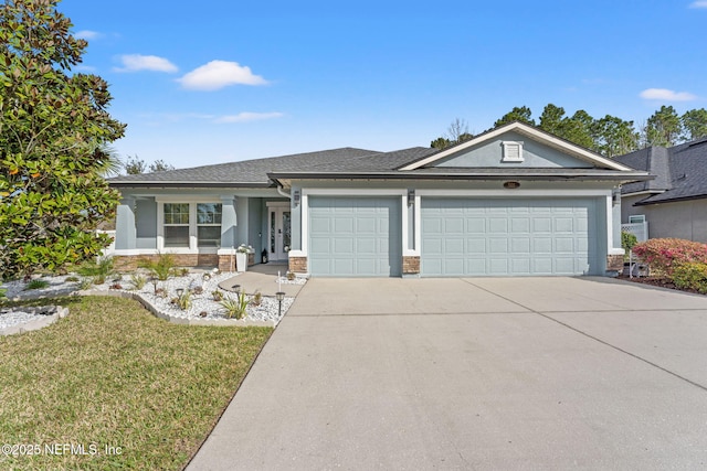 view of front of home with concrete driveway, stucco siding, an attached garage, a front lawn, and brick siding