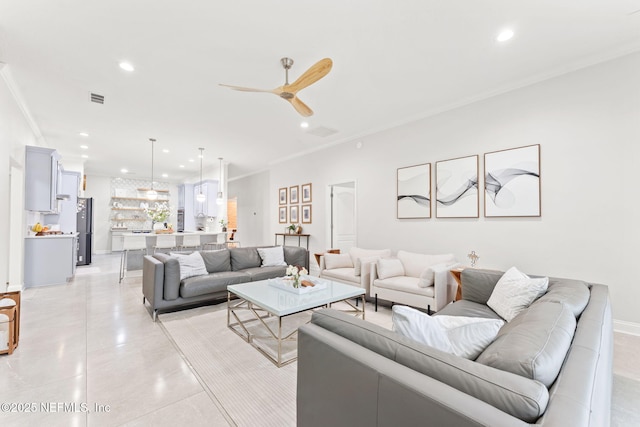 living room with recessed lighting, visible vents, a ceiling fan, and crown molding