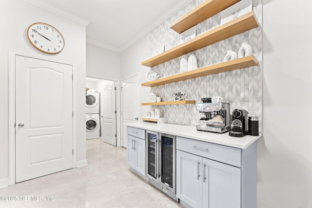 interior space with tasteful backsplash, light countertops, ornamental molding, stacked washer / drying machine, and open shelves