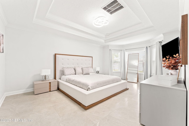 bedroom featuring a tray ceiling, baseboards, visible vents, and ornamental molding