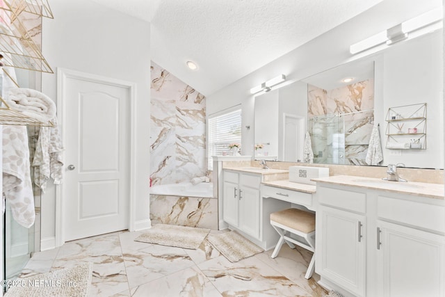 full bath with vanity, a marble finish shower, a textured ceiling, a garden tub, and marble finish floor