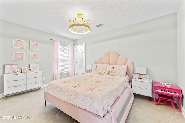 bedroom featuring tile patterned flooring, baseboards, visible vents, and a textured ceiling