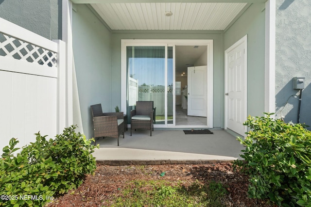 property entrance with stucco siding