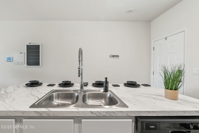 interior details featuring dishwasher, light countertops, and a sink