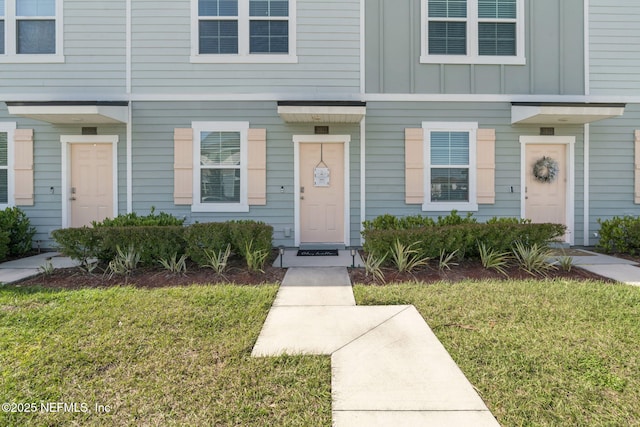 view of front of home featuring a front lawn and board and batten siding