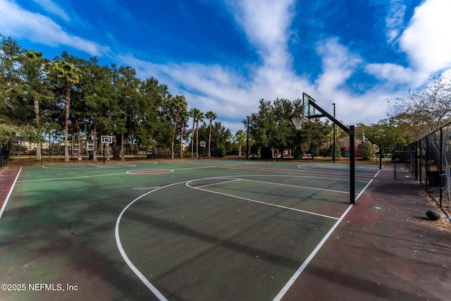 view of basketball court with community basketball court and fence