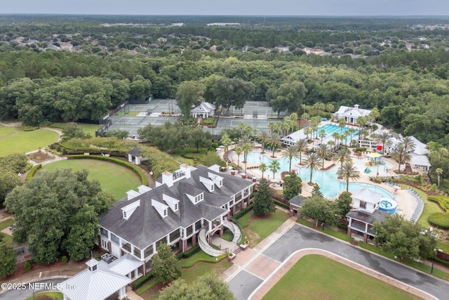 birds eye view of property featuring a view of trees