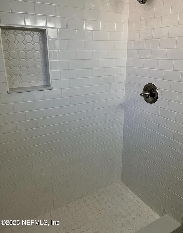 bathroom with a tile shower