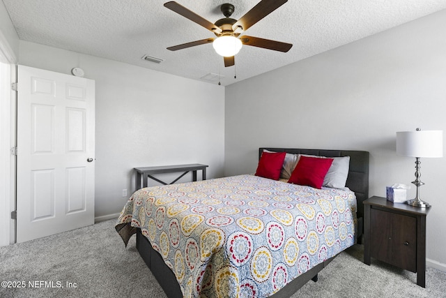 bedroom featuring ceiling fan, carpet flooring, visible vents, and a textured ceiling