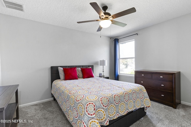 bedroom featuring visible vents, a textured ceiling, baseboards, and carpet floors