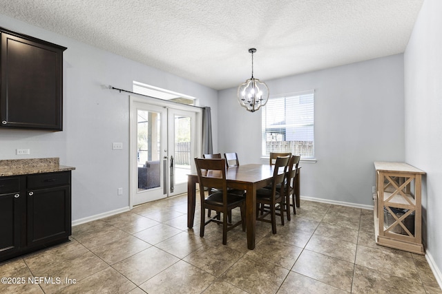 dining room featuring an inviting chandelier, a healthy amount of sunlight, and baseboards