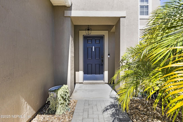 property entrance featuring stucco siding