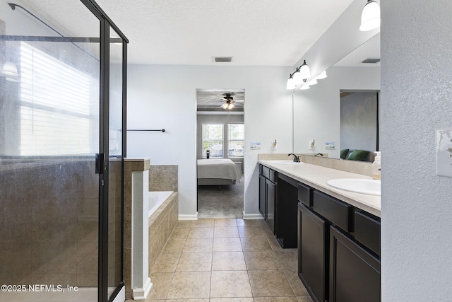 ensuite bathroom with visible vents, double vanity, a sink, a shower stall, and a bath