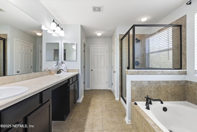 full bath featuring visible vents, a sink, a shower stall, double vanity, and a bath