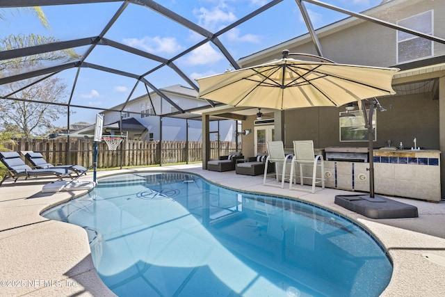 view of pool with glass enclosure, fence, a fenced in pool, outdoor lounge area, and a patio area