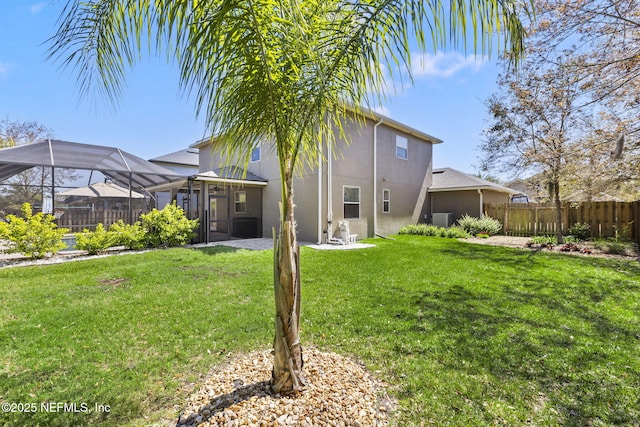 back of property with stucco siding, a lawn, central AC, fence, and a lanai