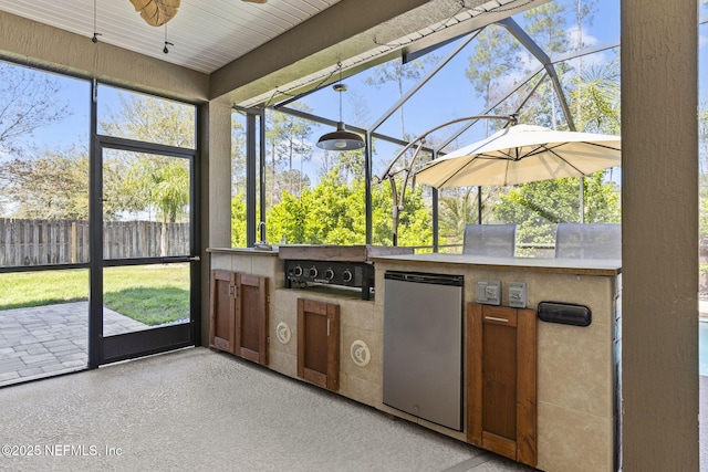 unfurnished sunroom with ceiling fan