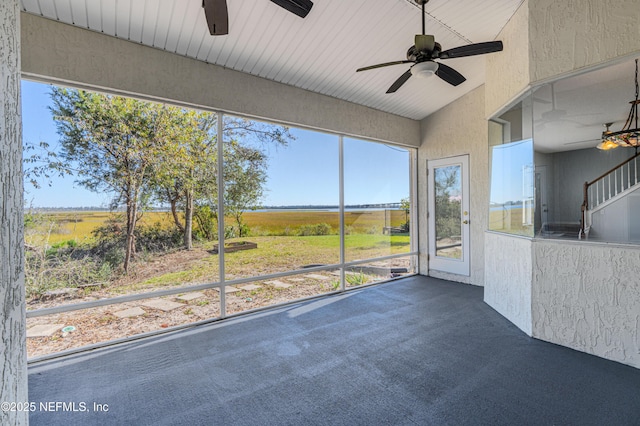 unfurnished sunroom featuring vaulted ceiling and ceiling fan