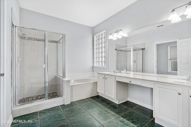 bathroom with double vanity, a garden tub, a shower stall, and a sink