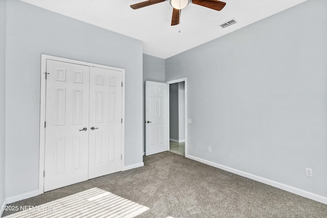 unfurnished bedroom with baseboards, visible vents, a ceiling fan, carpet flooring, and a closet