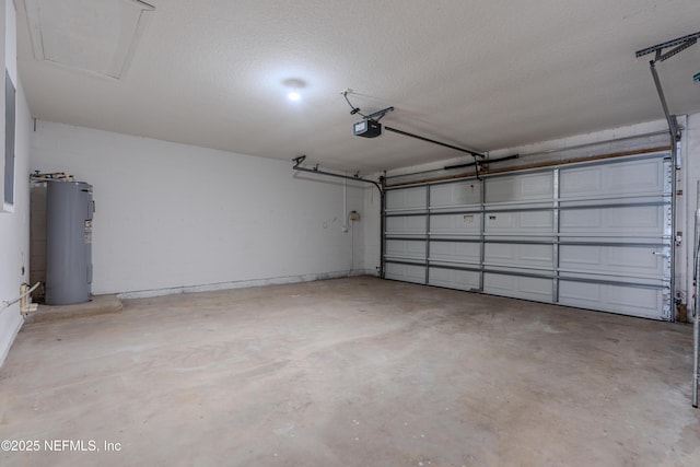 garage with concrete block wall, water heater, and a garage door opener