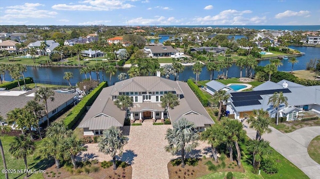 drone / aerial view with a residential view and a water view