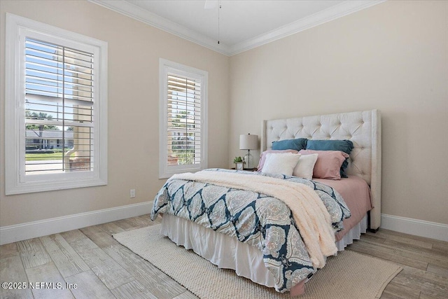 bedroom featuring crown molding, wood finished floors, and baseboards