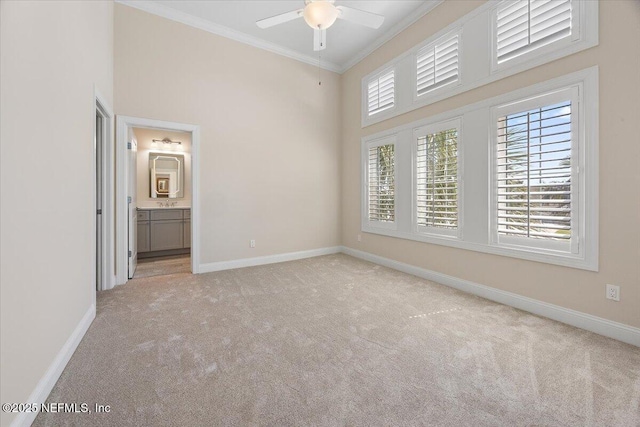 unfurnished room with baseboards, light carpet, a healthy amount of sunlight, and ornamental molding