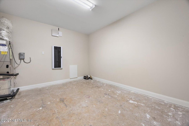 spare room with baseboards