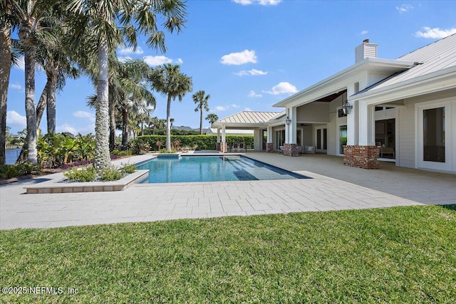 view of swimming pool featuring a lawn, a patio, and a fenced in pool