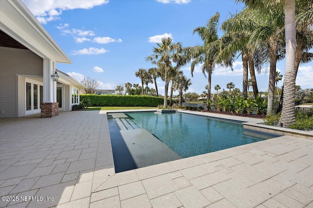 view of swimming pool featuring a patio area, a fenced in pool, and french doors