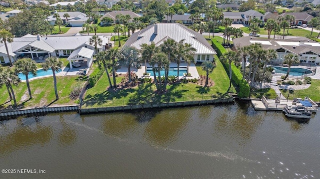 drone / aerial view featuring a residential view and a water view