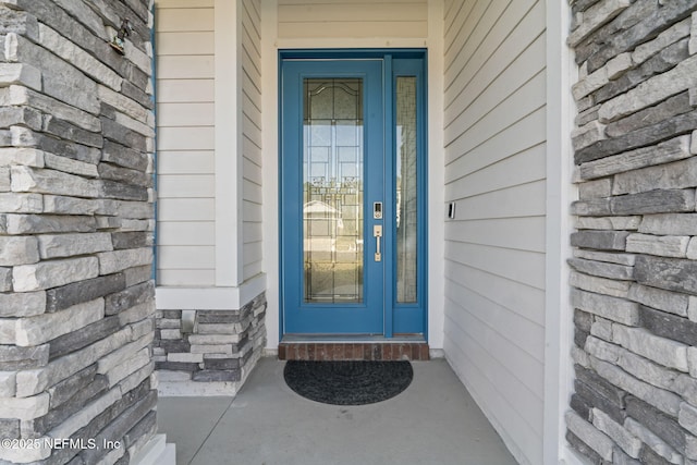 property entrance with stone siding