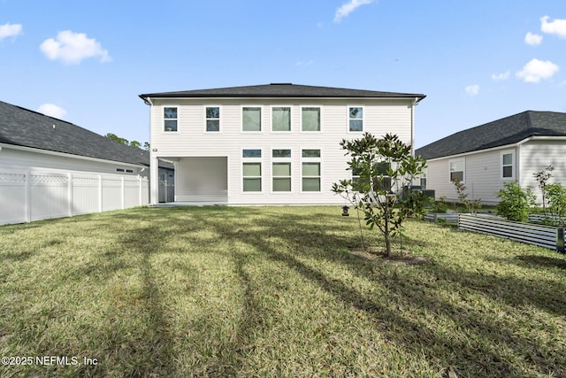 back of property featuring a yard and fence