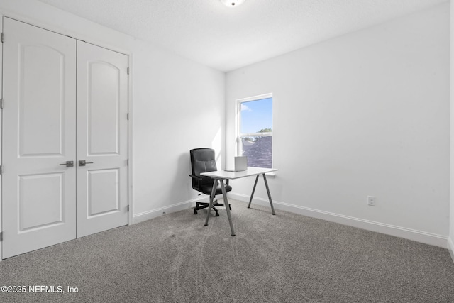 unfurnished office featuring carpet and baseboards