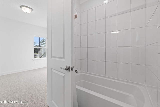 full bath with washtub / shower combination and baseboards