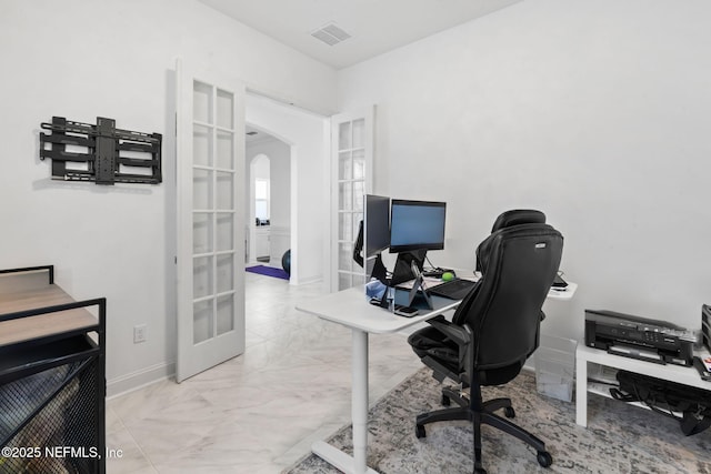 office area featuring arched walkways, visible vents, baseboards, marble finish floor, and french doors