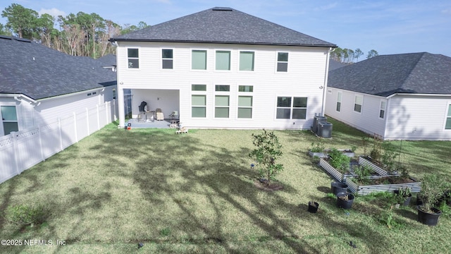 back of house with a lawn, a patio area, and fence