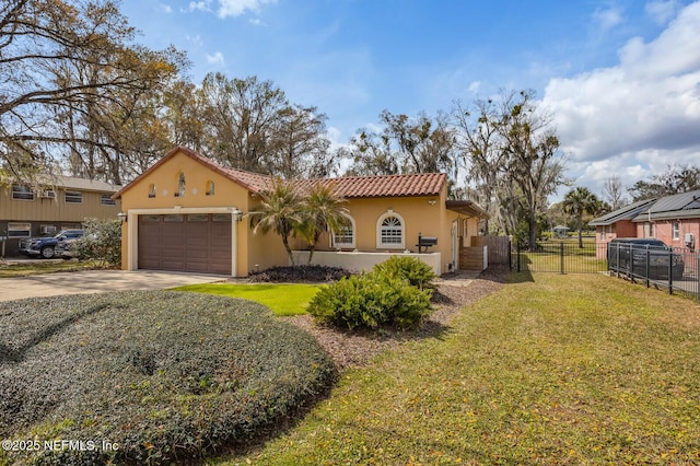 mediterranean / spanish-style house with stucco siding, an attached garage, fence, driveway, and a front lawn