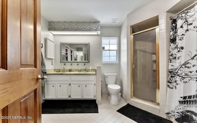 full bathroom featuring a stall shower, visible vents, vanity, and toilet