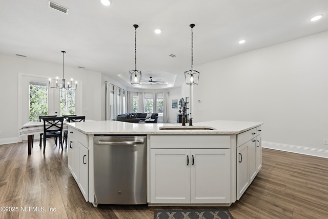 kitchen with stainless steel dishwasher, a kitchen island with sink, visible vents, and white cabinetry