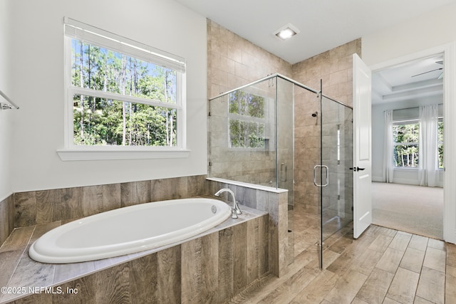 bathroom featuring a garden tub and a shower stall