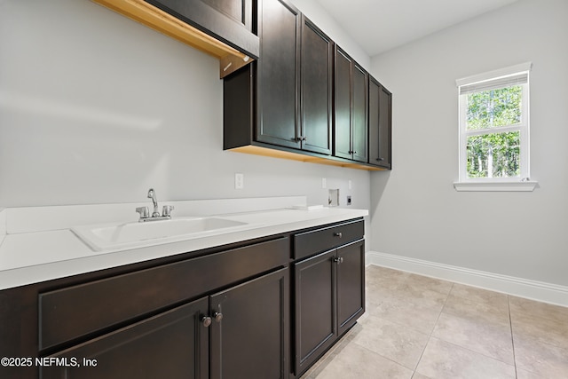 laundry area with washer hookup, light tile patterned flooring, cabinet space, hookup for an electric dryer, and a sink