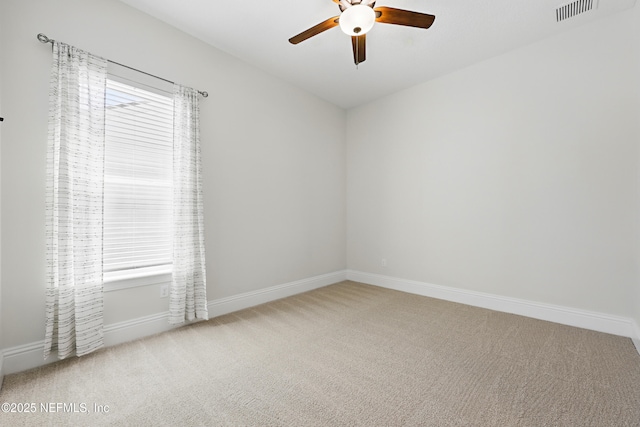 spare room with visible vents, baseboards, ceiling fan, and carpet floors