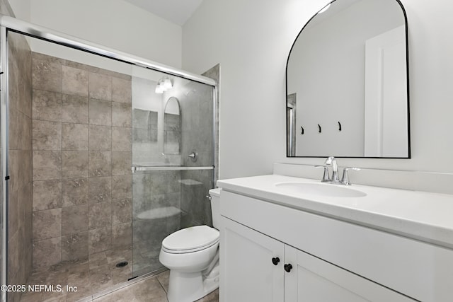 full bathroom with tile patterned floors, vanity, toilet, and a shower stall