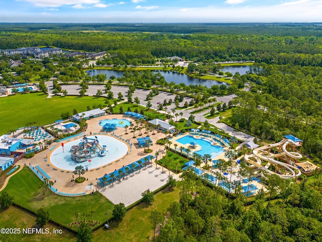 bird's eye view with a water view and a wooded view