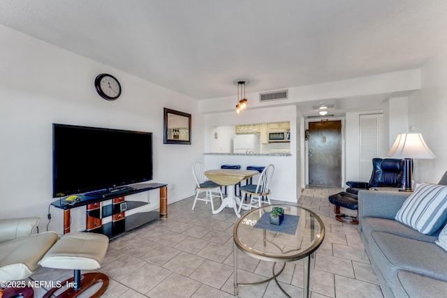 living area featuring visible vents and tile patterned floors