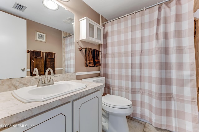 bathroom with visible vents, toilet, a shower with curtain, tile patterned flooring, and vanity