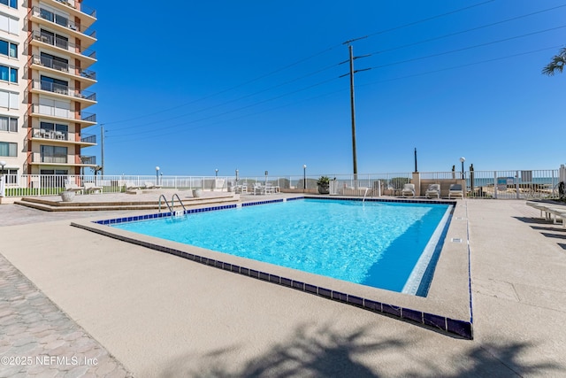 pool featuring a patio area and fence